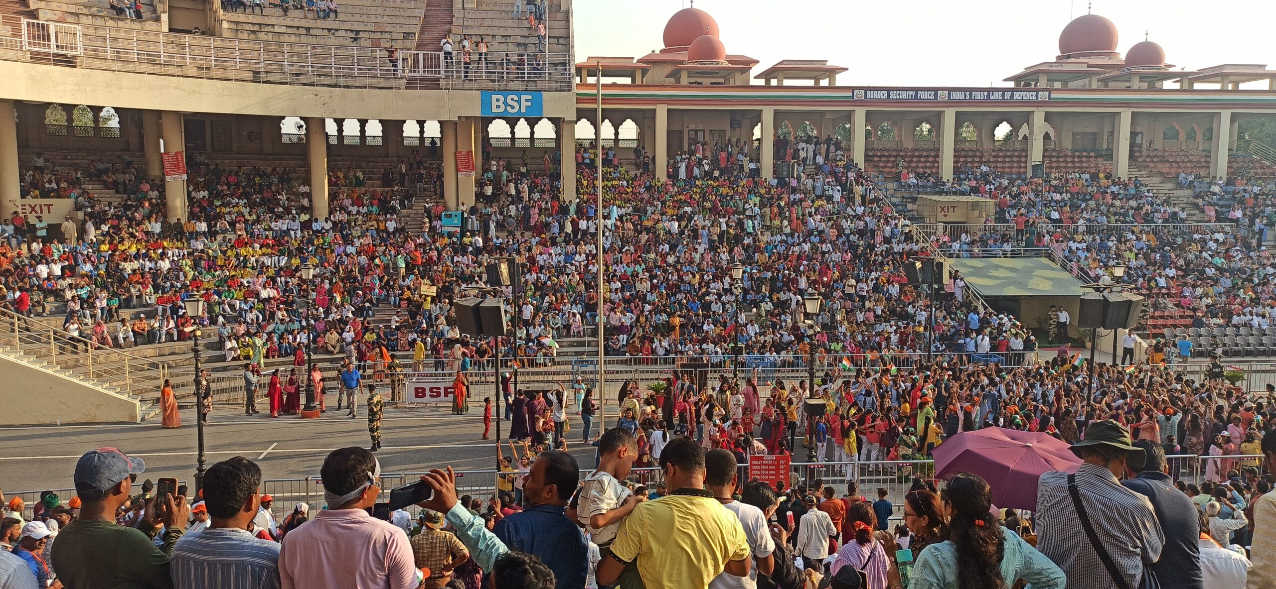 "Indian and Pakistani soldiers performing the Beating Retreat Ceremony at Wagah Border, with crowds watching and national flags displayed."